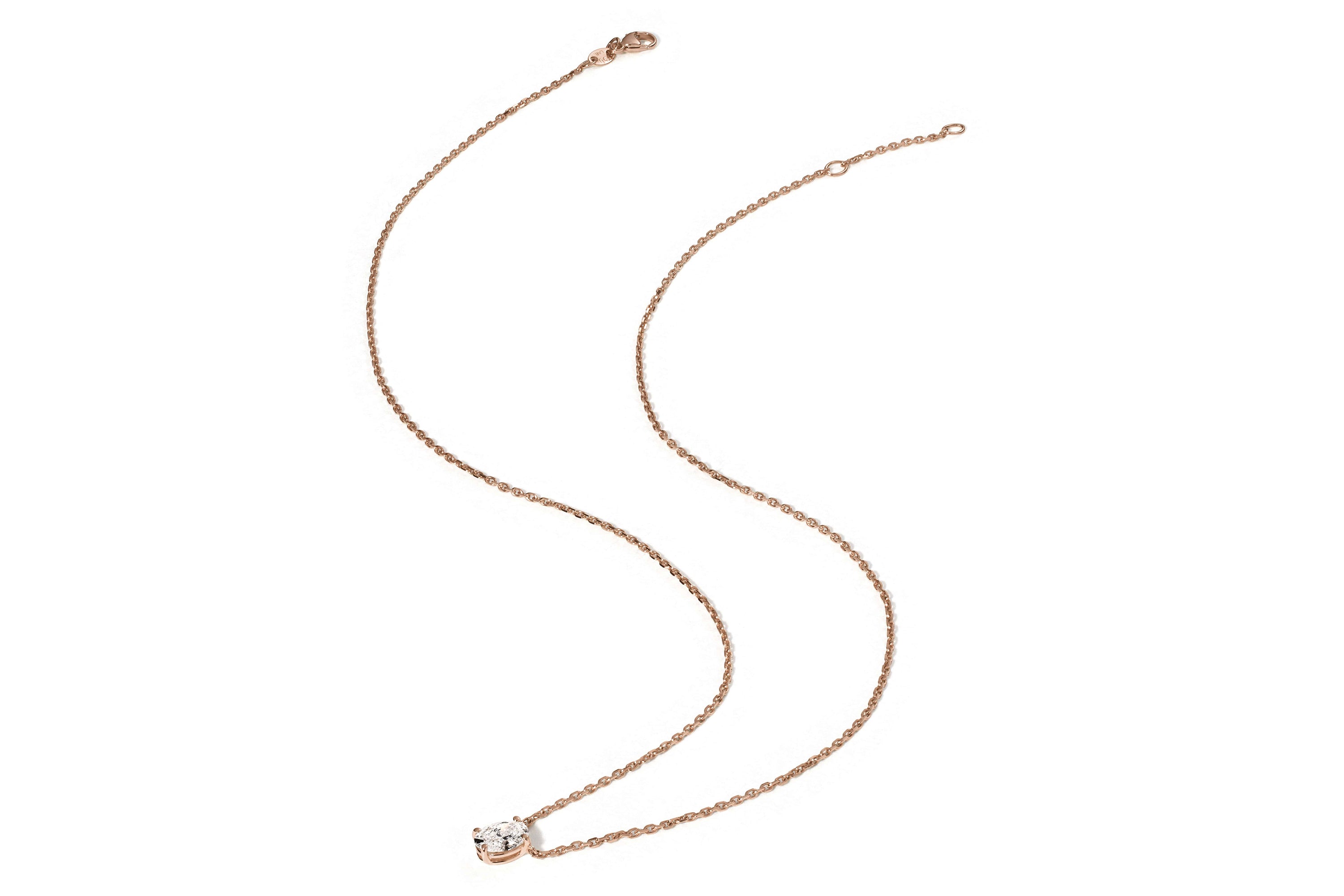Die ERATO ROSÉGOLD-Halskette von Atelier Sofia besteht aus einer zarten Kette aus 18 K Roségold mit einem runden Anhänger, der mit einem klaren, im Labor gezüchteten Diamanten besetzt ist und schlichte Eleganz ausstrahlt. Der Verschluss befindet sich auffälligerweise am anderen Ende des Anhängers.